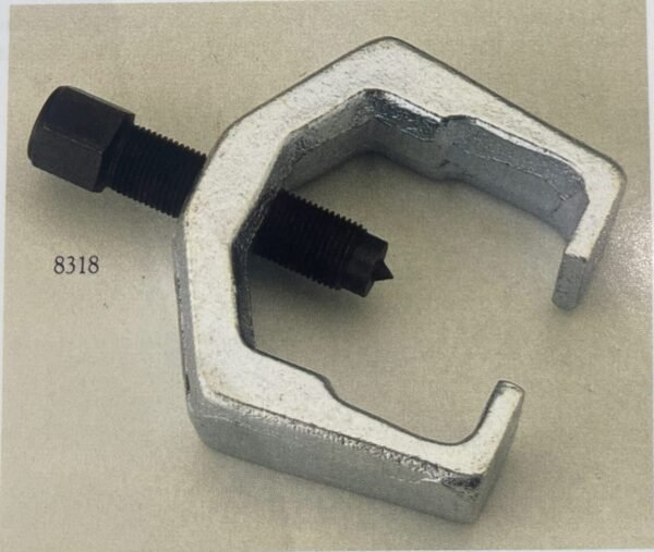 Pitman arm puller removing a steering arm from vehicle